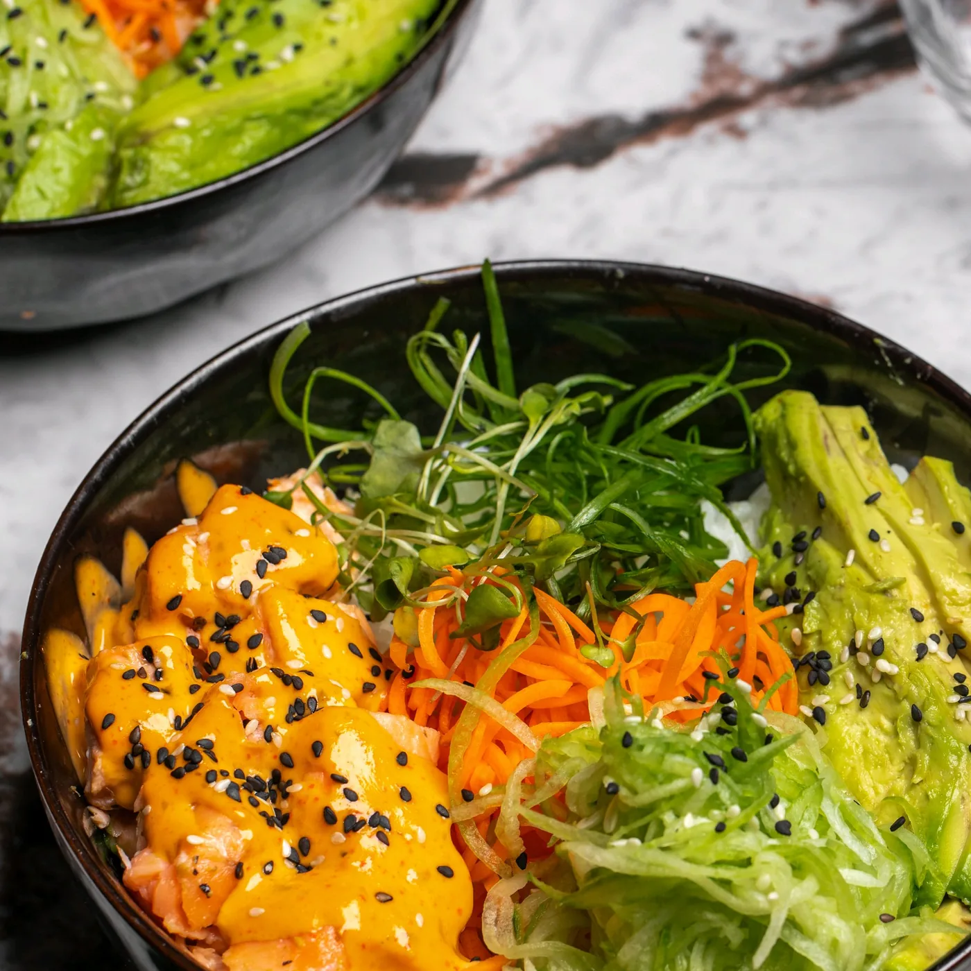 A bowl photographed at Mousai with salmon, vegetables and greens