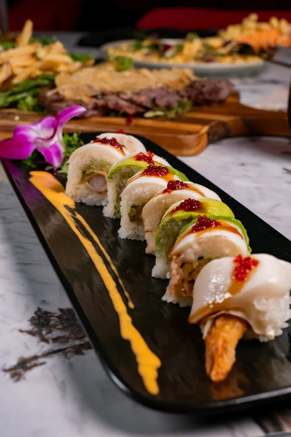 Mousai sushi on its original black platter