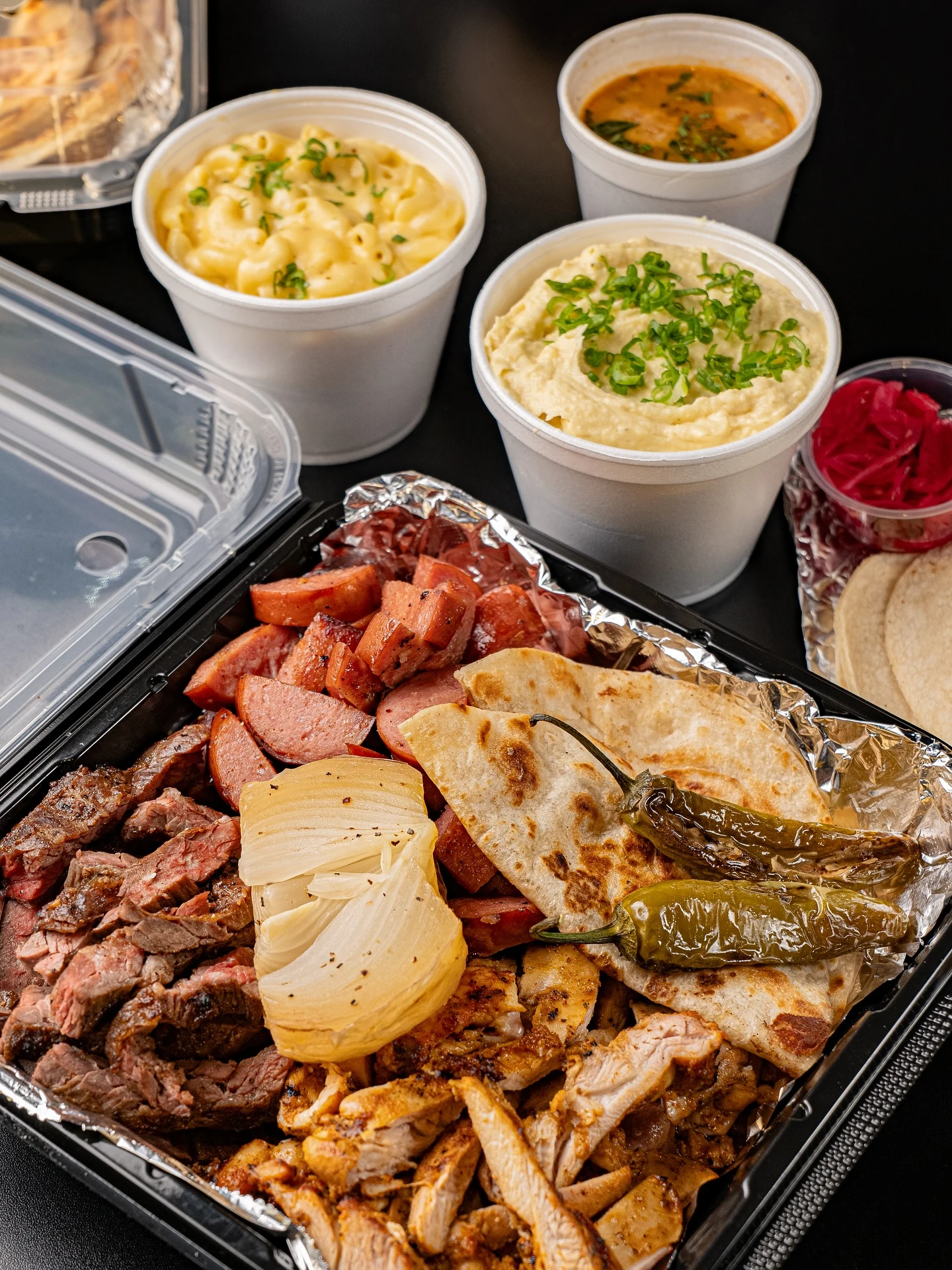 Corte Fino’s parrillada mixta with beef, chicken, sausage, tortillas, grilled onions, chiles and sides