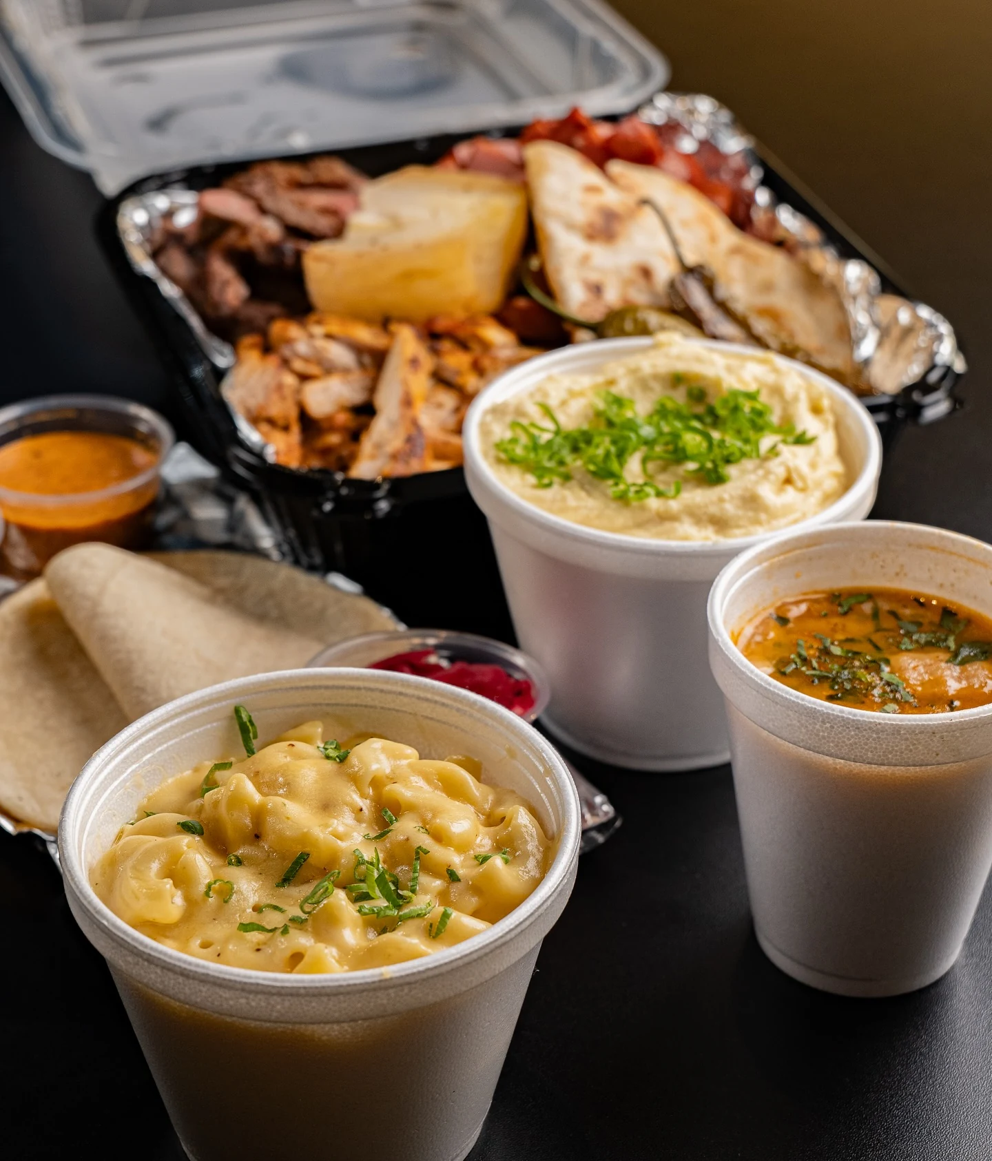 Corte Fino’s chicken parrillada with tortillas, salsas, charro beans, mashed potatoes and mac and cheese