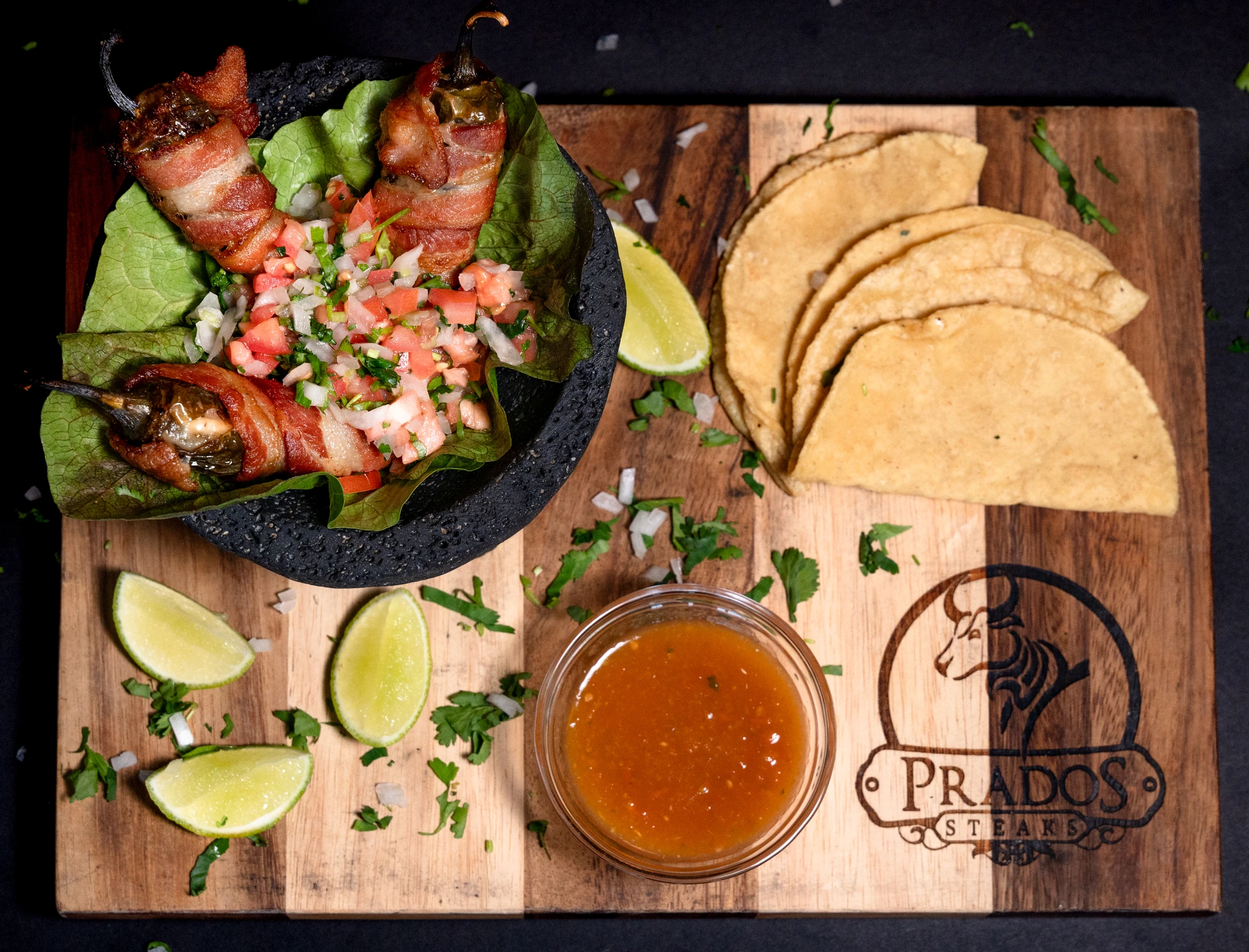 Stuffed peppers, tortillas and salsa on Prado’s original serving board, with its genuine mark visible