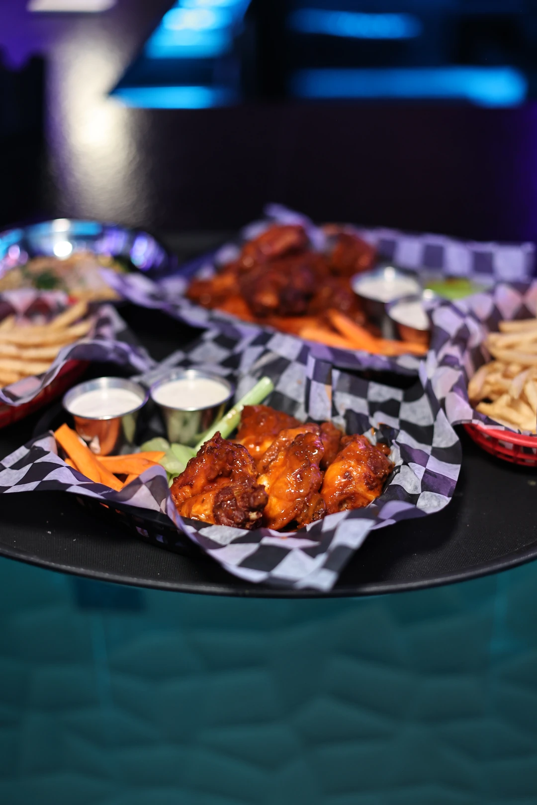 Wings, celery, carrots and sauces in the real blue-lit Skybox dining room.