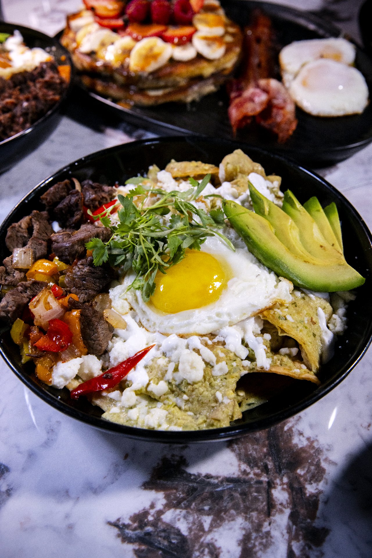 Mousai chilaquiles de ribeye with egg and avocado