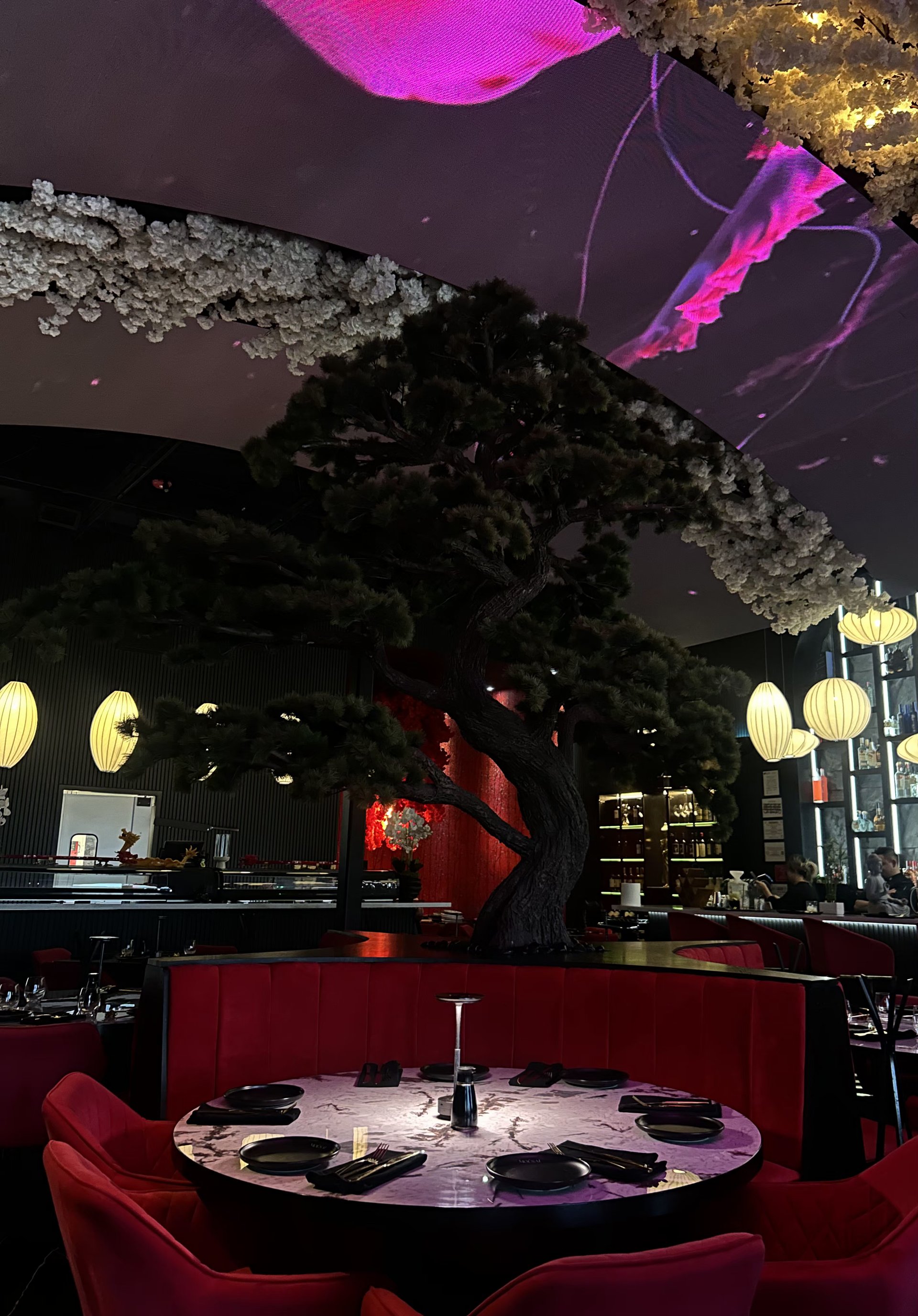 Mousai’s actual dining room, red seating and illuminated tree